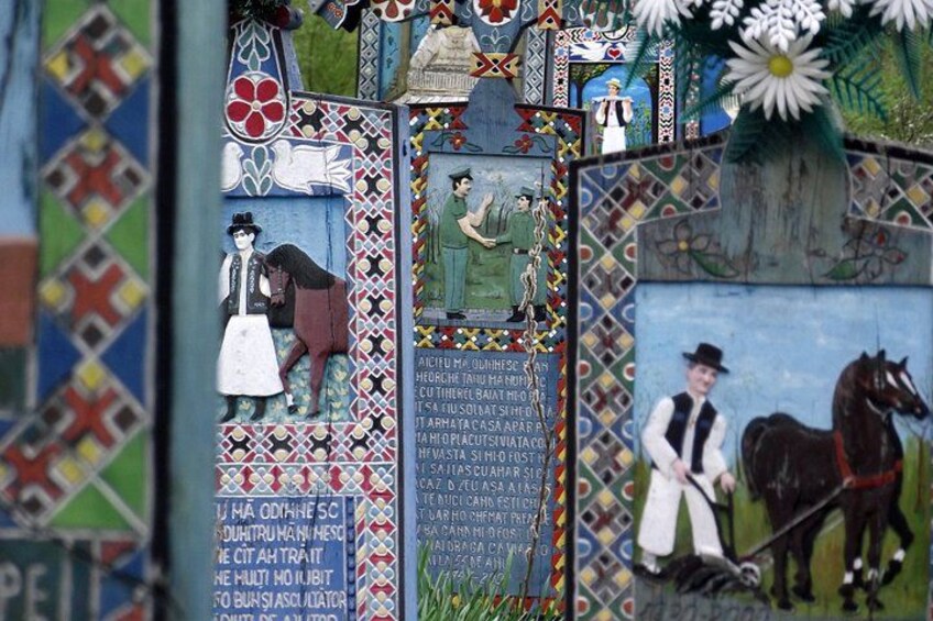 A wall with various artworks, including a horse and rider, a woman in a dress, and a man in a suit. 3