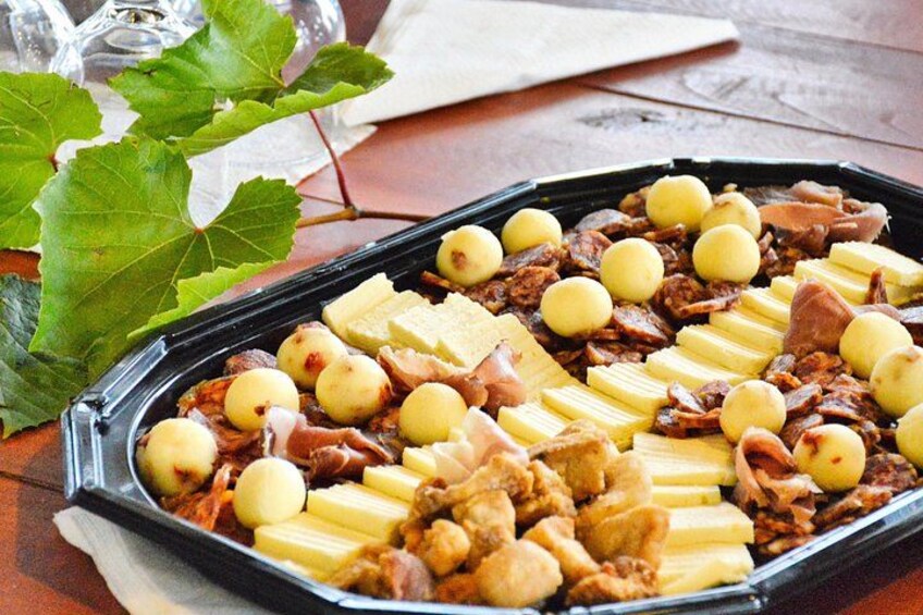 A charcuterie board with various meats, cheeses, and fruits. 4