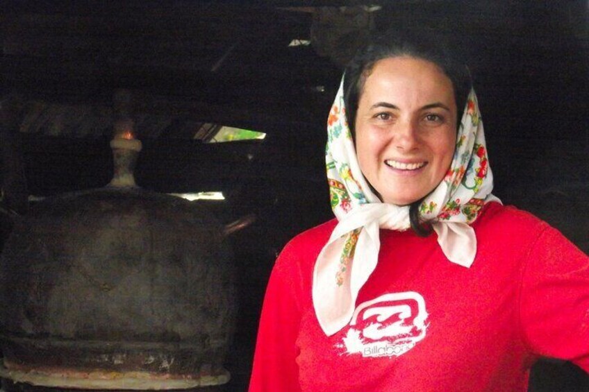 A person wearing a red shirt with a logo and a patterned scarf. 5