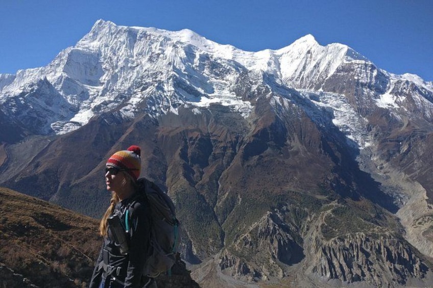 A person hiking with a mountain range in the background. 2