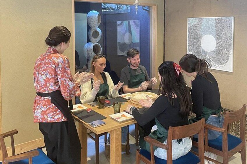 Un groupe de personnes est réuni autour d’une table, devant de la nourriture, et s’adonne à une conversation animée. 3