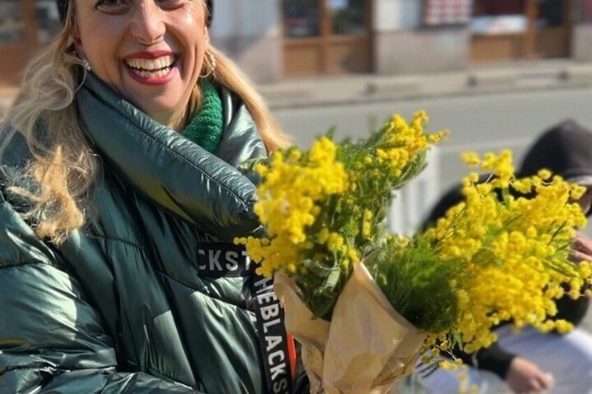 A person holding a bouquet of yellow flowers. 4