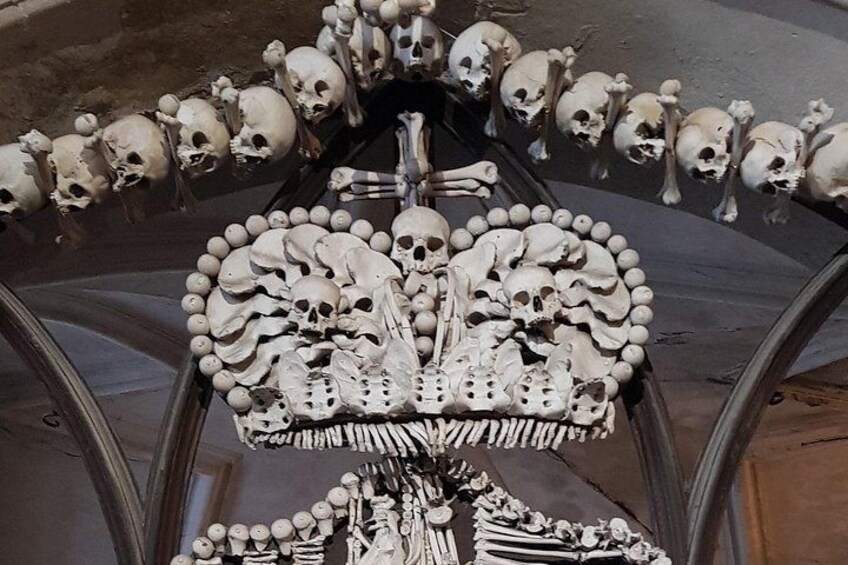 A skeletal structure with multiple skulls arranged in a circular pattern. 4
