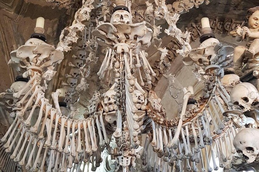 A collection of human skeletons arranged in a complex, ornate structure. 3