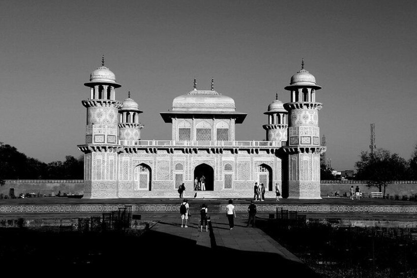 A large, ornate building with domes and minarets, surrounded by a body of water. 3