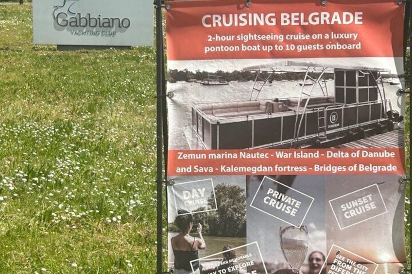 A sign for a 2-hour sightseeing cruise on a luxury pontoon boat. 2