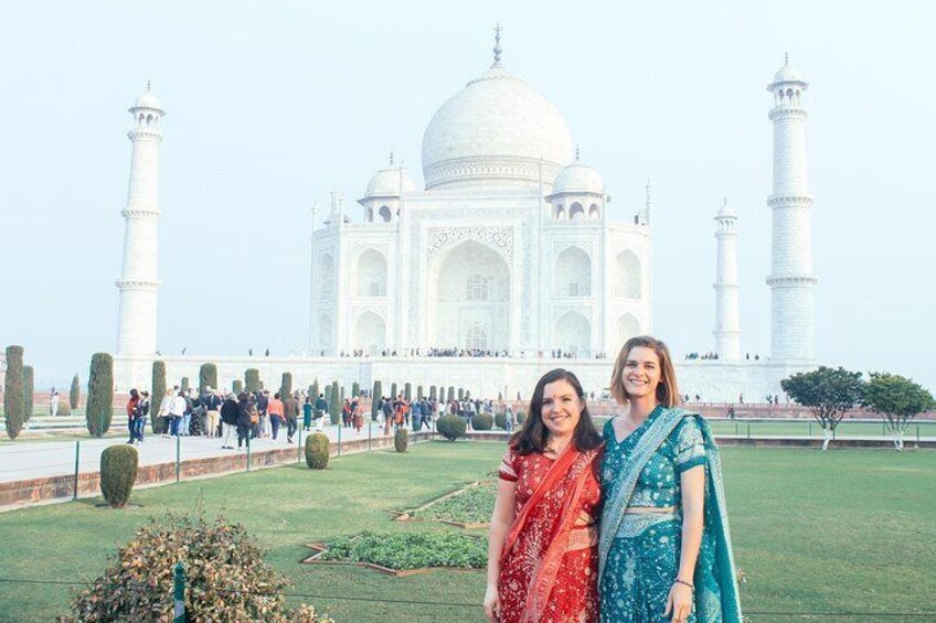 De Taj Mahal met twee personen op de voorgrond. 1