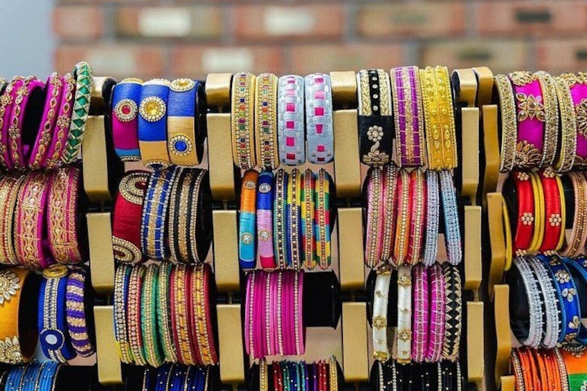 A display of colorful bangles on a rack. 3