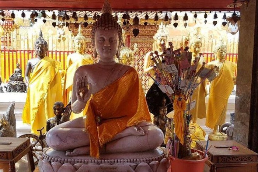 En stor sittande Buddha-staty i ett utsmyckat tempel. 1
