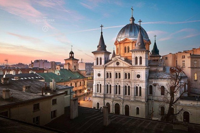 A historic church with a large dome and multiple spires, surrounded by urban buildings. 4