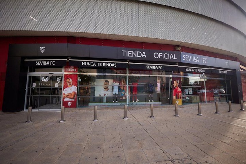 A Sevilla FC store with glass windows and a red and black facade. 2