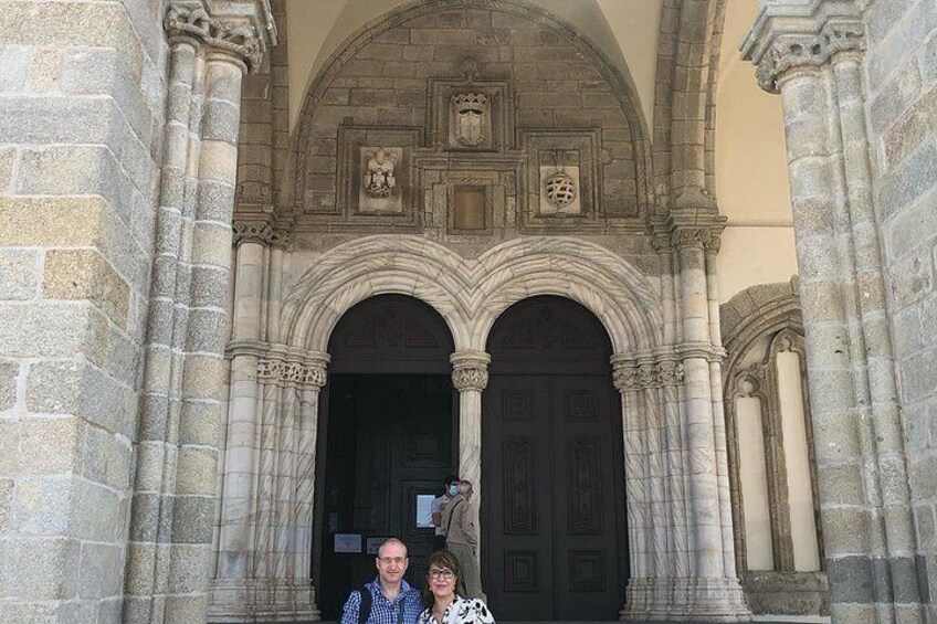 A stone building with two large arched doorways and a central decorative element above the doors. 4