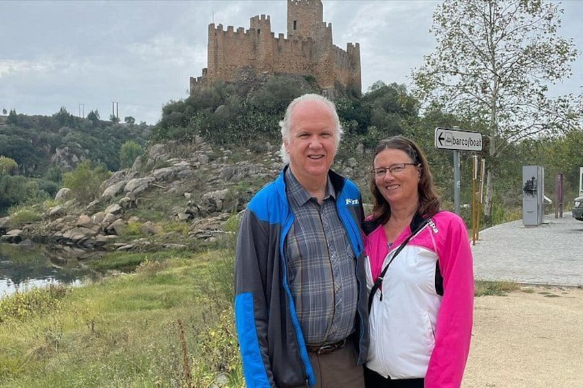 A castle on a hill, a sign for Barco Boat, and a river. 3