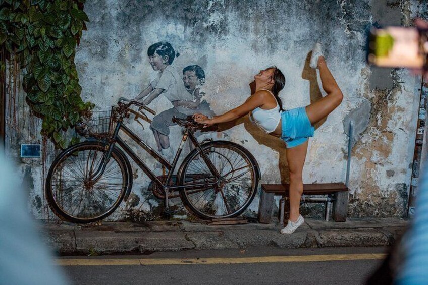 A person performing a handstand on a bicycle. 1