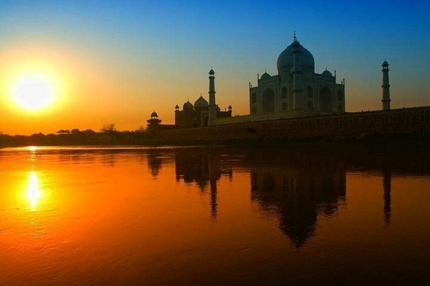 The Taj Mahal at sunset with its reflection in the water. 5