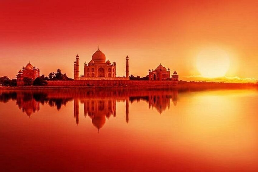 The Taj Mahal at sunset with its reflection in the water. 4