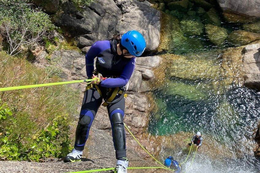 Une personne qui descend en rappel une falaise rocheuse pour atterrir dans une étendue d’eau. 4