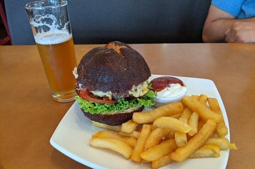 Burger on pretzel bun with an local artisanal beer