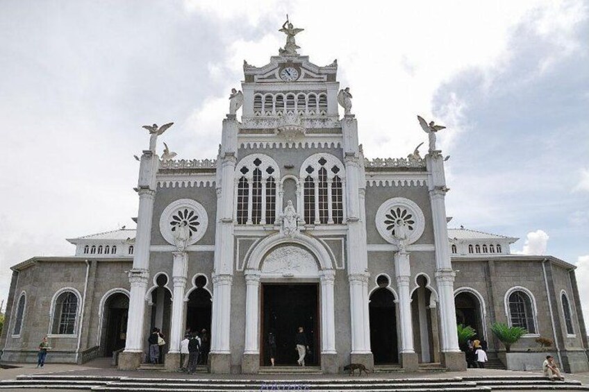 A large, ornate church with multiple arched windows and statues on the facade. 2