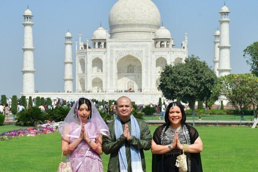 The Taj Mahal with three people in front. 2