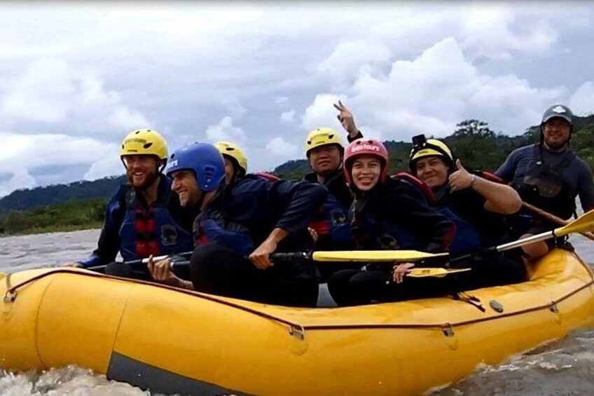 A group of people in a yellow raft on a river. 3