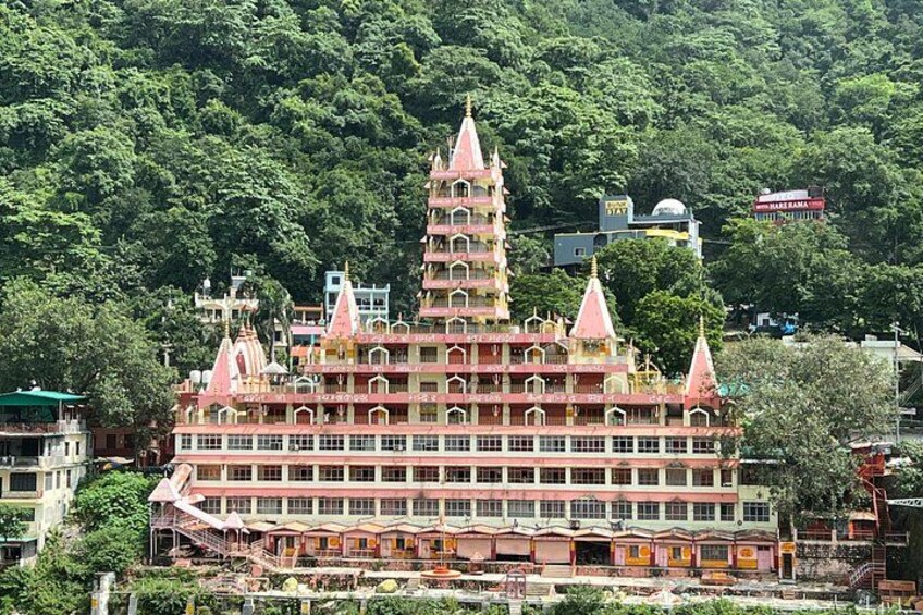 A multi-tiered temple with multiple spires, surrounded by lush greenery. 3
