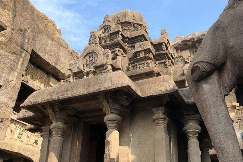 A large stone structure with intricate carvings and columns. 4