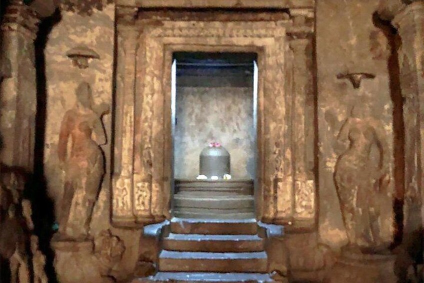 A stone staircase leading to a doorway with a statue on each side. 2