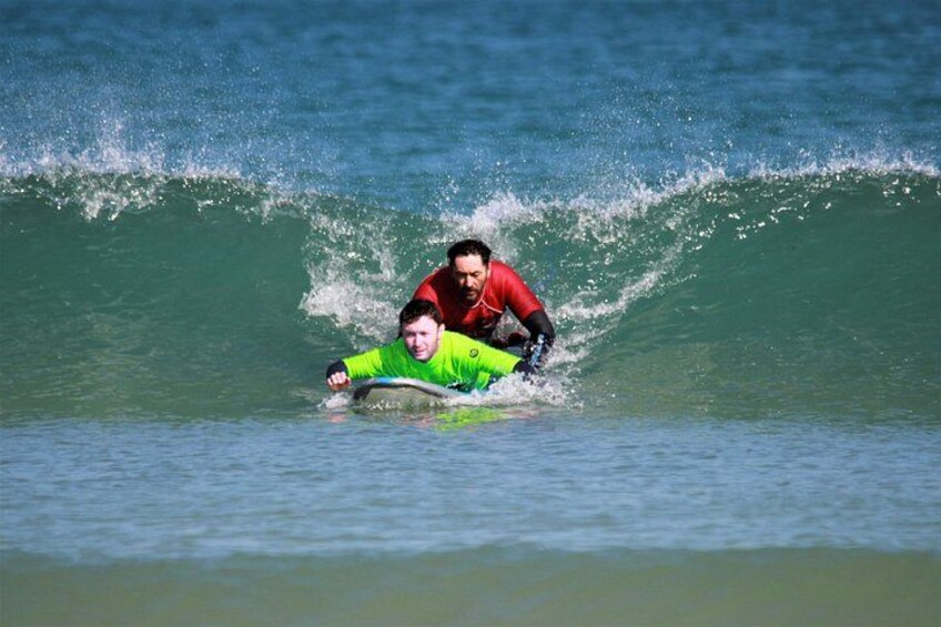 Two people surfing on a wave. 4
