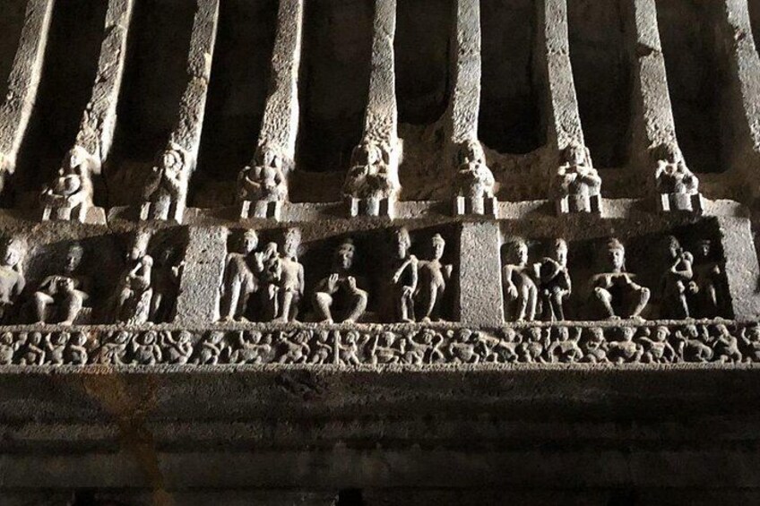 A stone relief with figures in various poses, possibly depicting a historical or mythological scene. 4