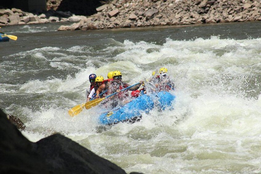 A white water rafting team navigating through turbulent rapids. 2