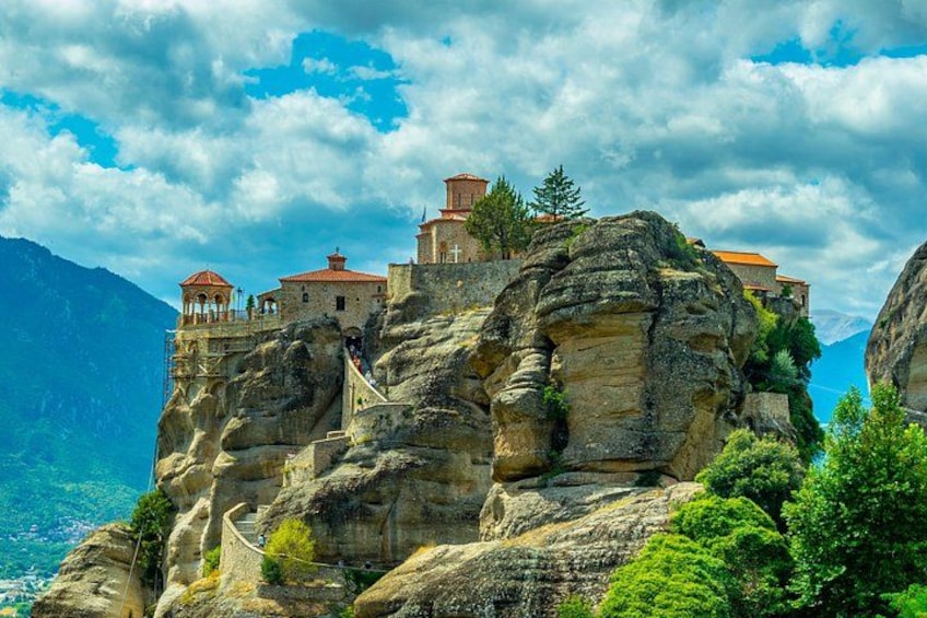 A monastery on a rocky cliff with a clear sky. 4