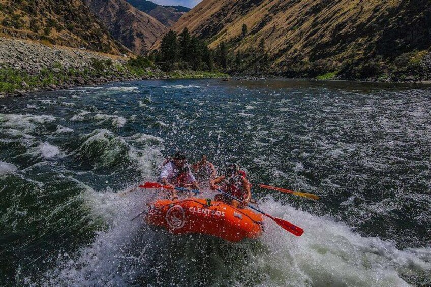A white water rafting trip on a river surrounded by mountains. 1