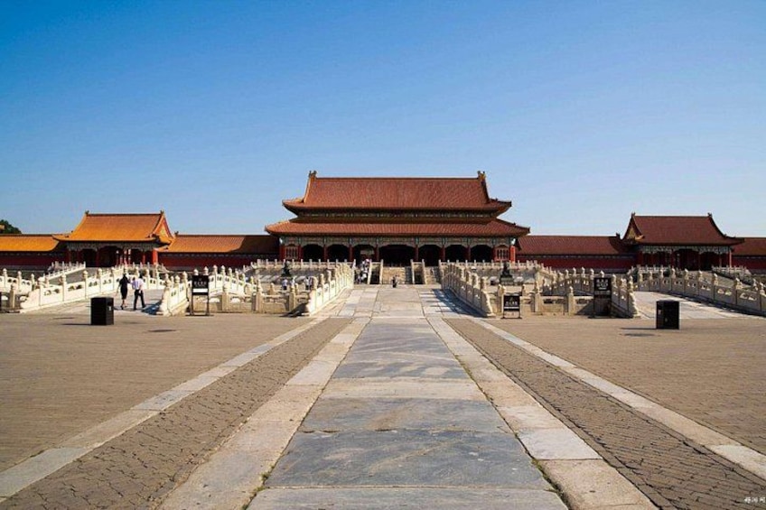 A traditional Chinese building with a red roof, a stone pathway leading to it, and a white fence surrounding the area. 1