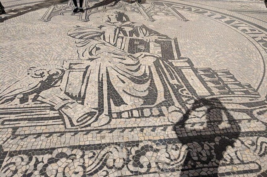 A detailed mosaic with a central figure seated, surrounded by intricate patterns and smaller figures. 3