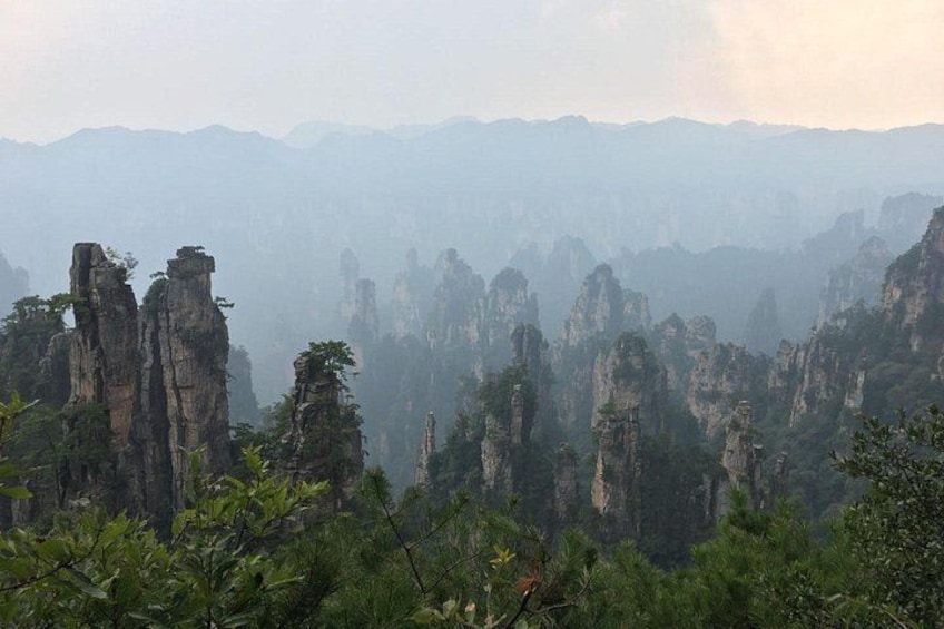 A landscape with towering rock formations and dense greenery. 3