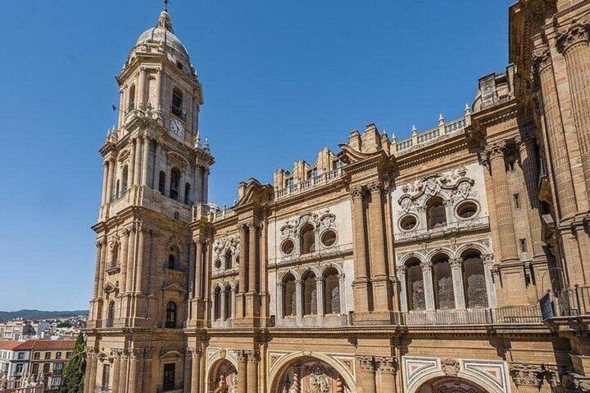 A historic building with a prominent bell tower and ornate architectural details. 2