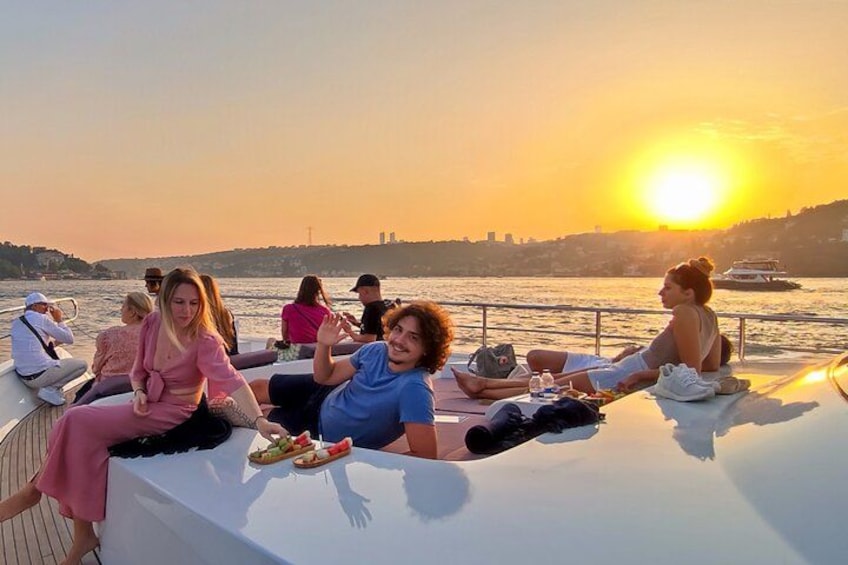 A group of people on a boat during sunset. 4