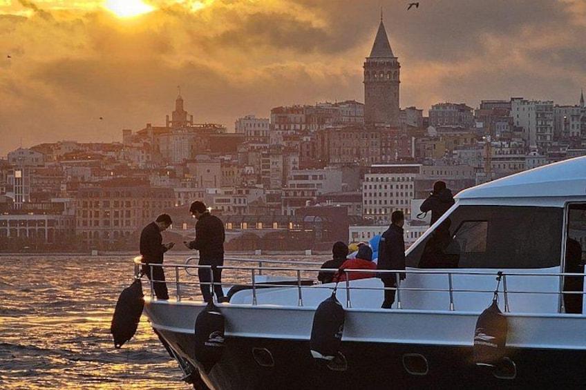 A boat with people on the deck, a city skyline in the background, and a tower. 5
