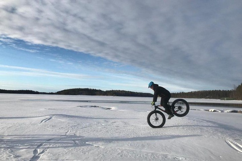 A person riding a bicycle on a frozen lake. 2
