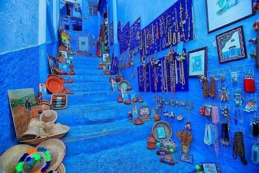 A staircase with various items displayed on the walls, including jewelry and decorative objects. 1