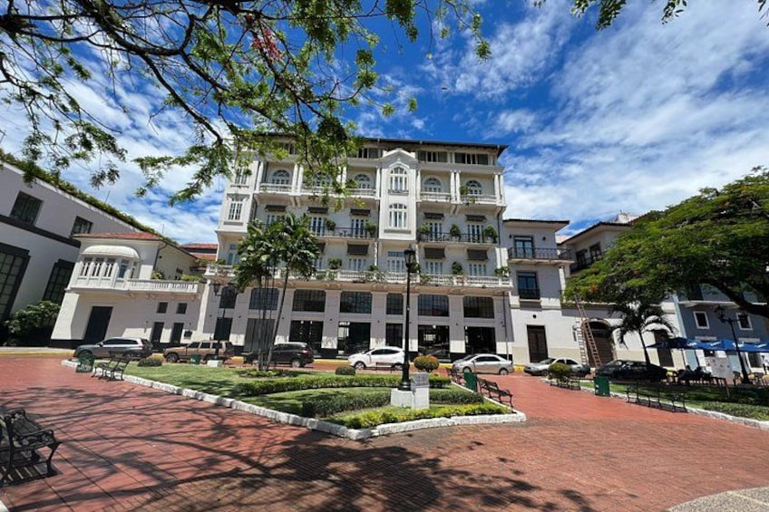 A multi-story building with a central courtyard, surrounded by smaller structures. 2
