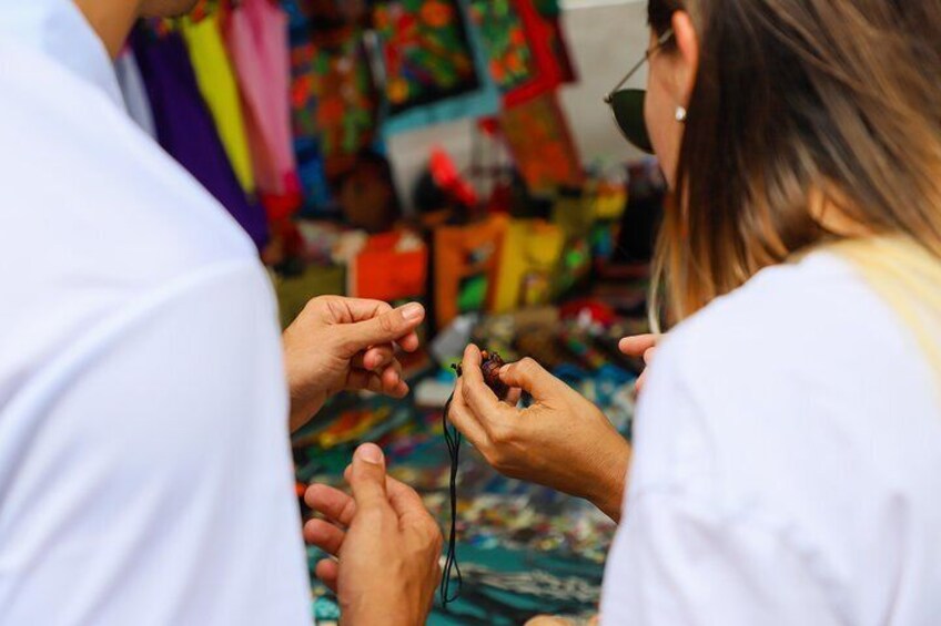 A person holding a small object, possibly a tool, with another person assisting. 5