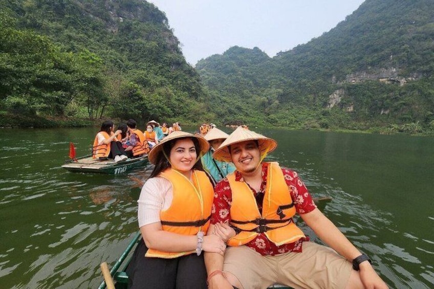 A group of people in a boat on a river surrounded by lush greenery. 4