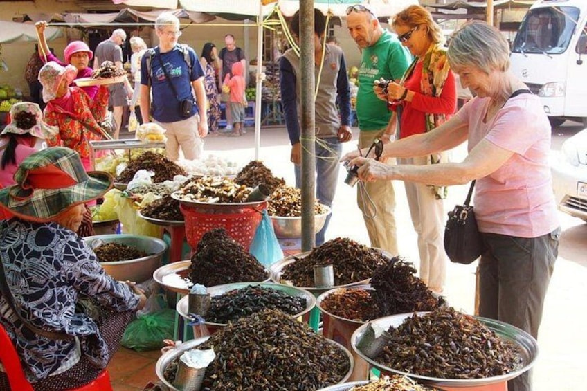 A market with people buying and selling dried fish. 1