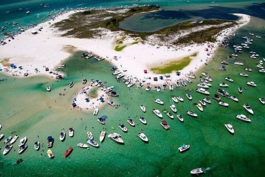 A beach with numerous boats and people. 3