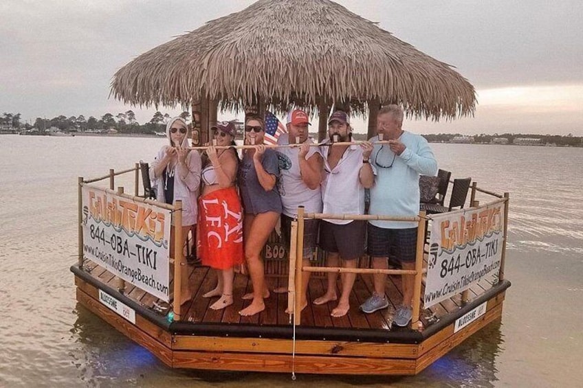 A wooden boat with a thatched roof, surrounded by calm water. 4