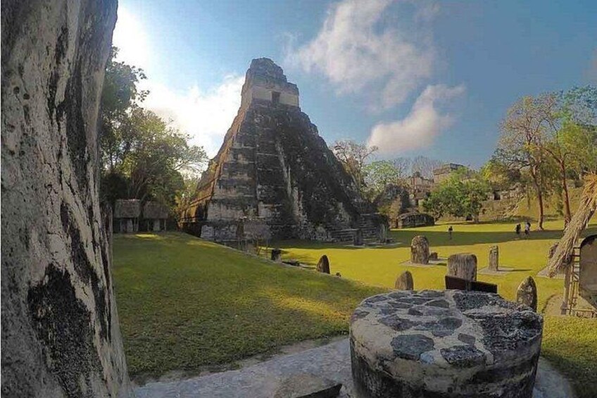 A pyramid structure, a grassy area, and stone headstones. 4