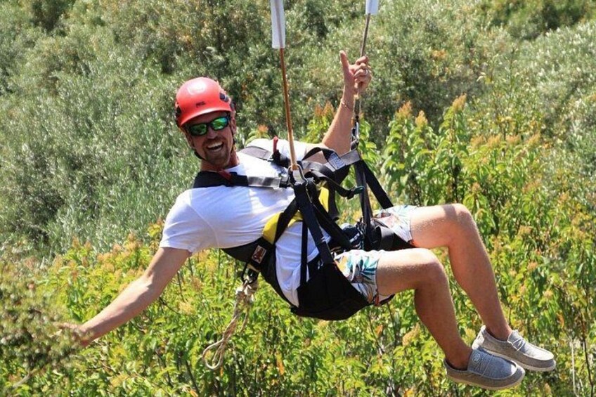 A person zip-lining through a forested area. 2