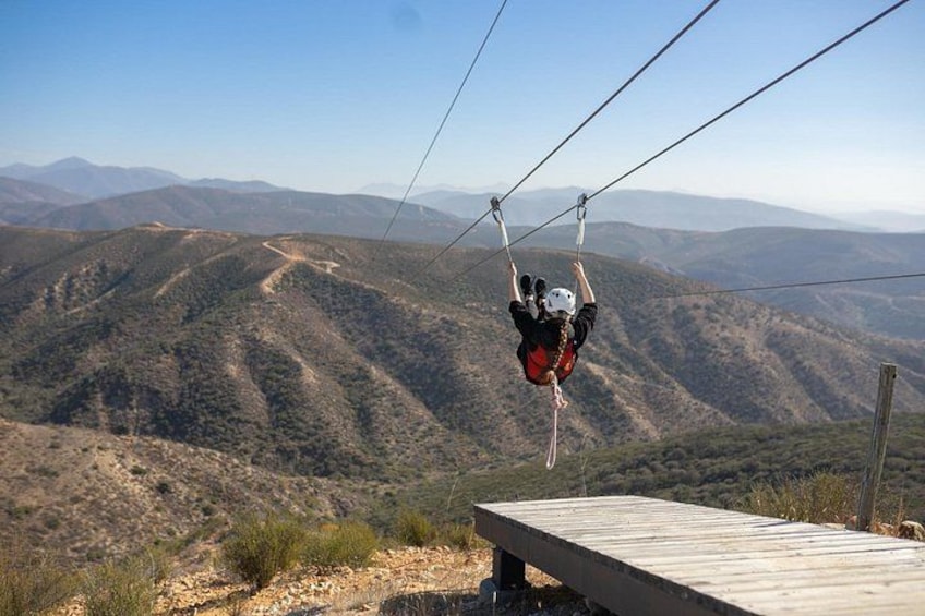 A person bungee jumping with a mountainous landscape in the background. 3
